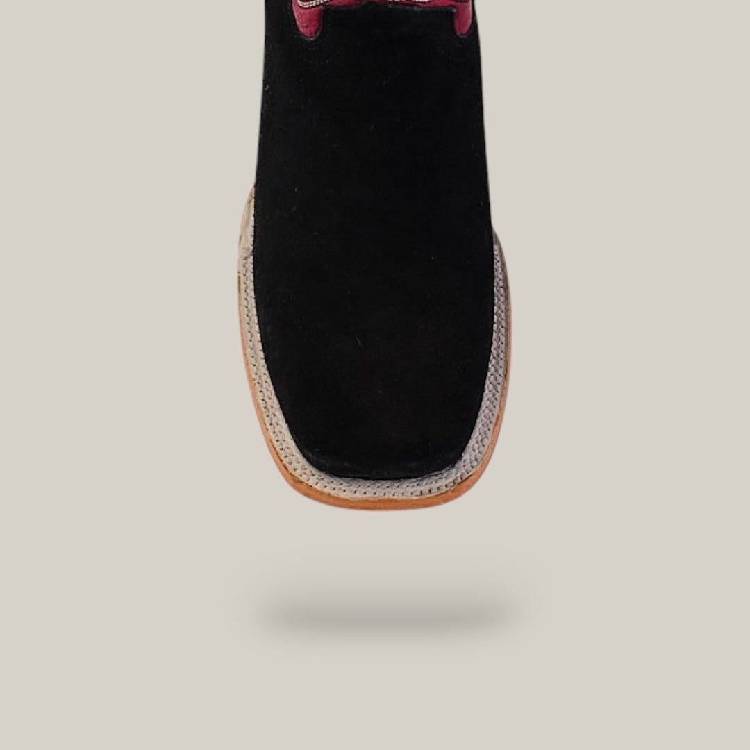 The Black Suede - Platinum - Square Toe boots feature a square toe, light brown sole, and platinum accent near the laces. Styled with western flair, they are showcased against an off-white background.