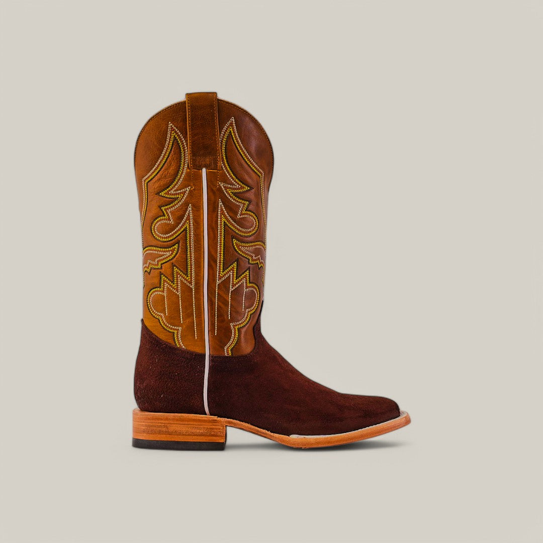 The Brown Suede - Platinum - Square Toe is a single cowboy boot with a brown suede leather upper featuring intricate stitching, a darker suede lower section, and a wooden heel, displayed against a plain light background.