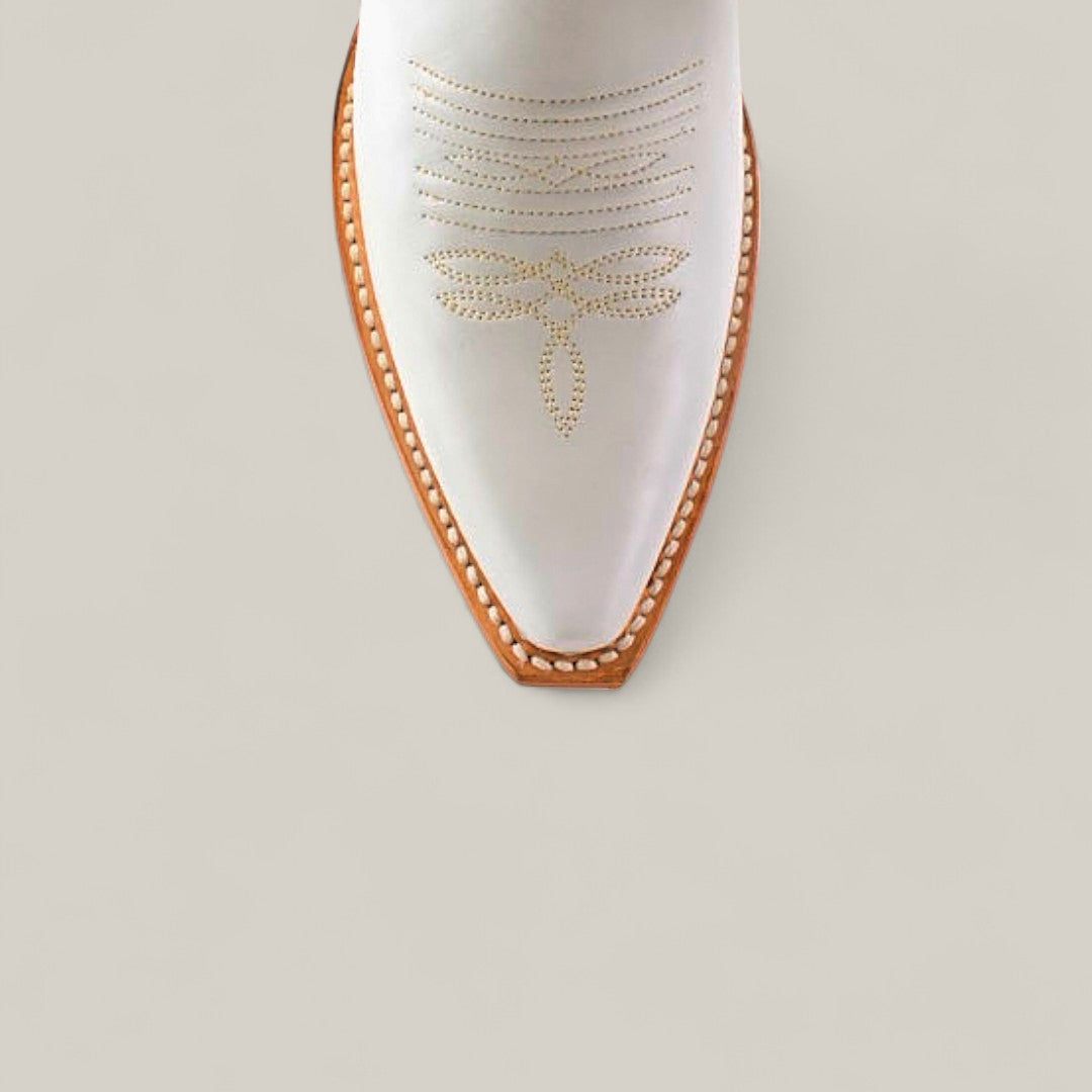 The Kellie Frost White Leather Sole cowboy boot features a tall shaft, snip toe, tan stitching, and a light brown sole, shown from above on a light grey background.