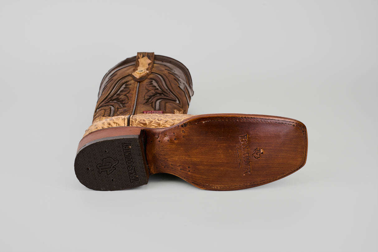 The Exotic Caiman Hornback - Antique - Rodeo Toe is a brown cowboy boot with a brown sole, made from exotic caiman leather and featuring an antique rodeo toe.