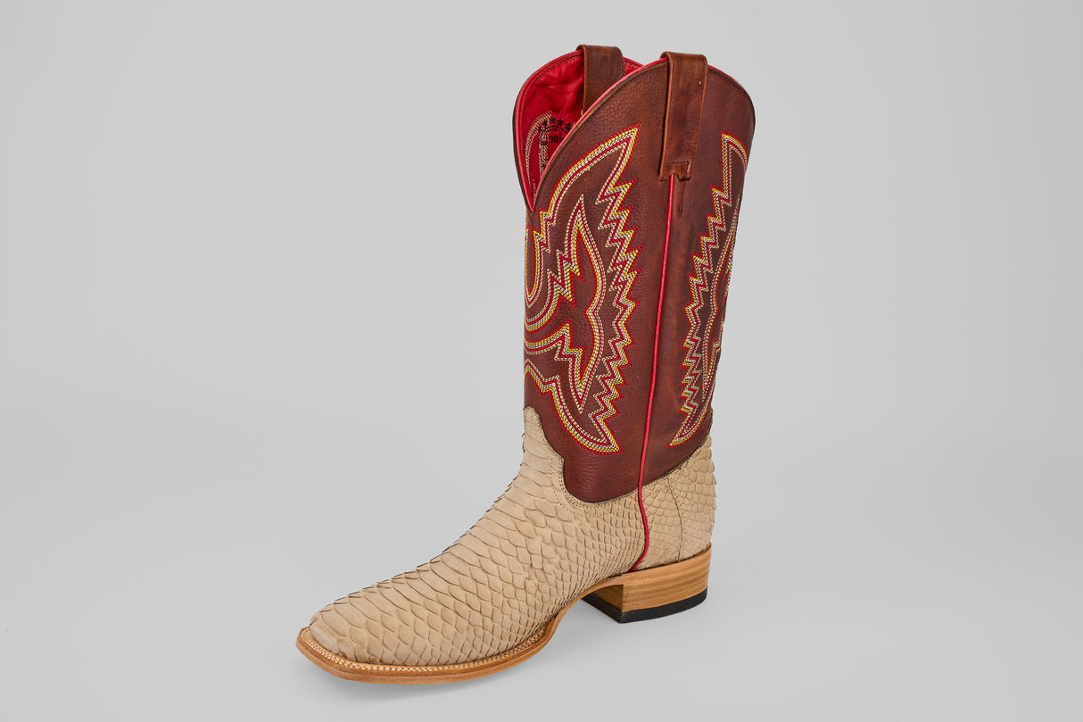 The Braxton - Cappuccino - Square Toe features a tan textured python leather foot, a tall brown shaft with yellow and red stitching, and a red interior lining, all displayed on a plain gray background.
