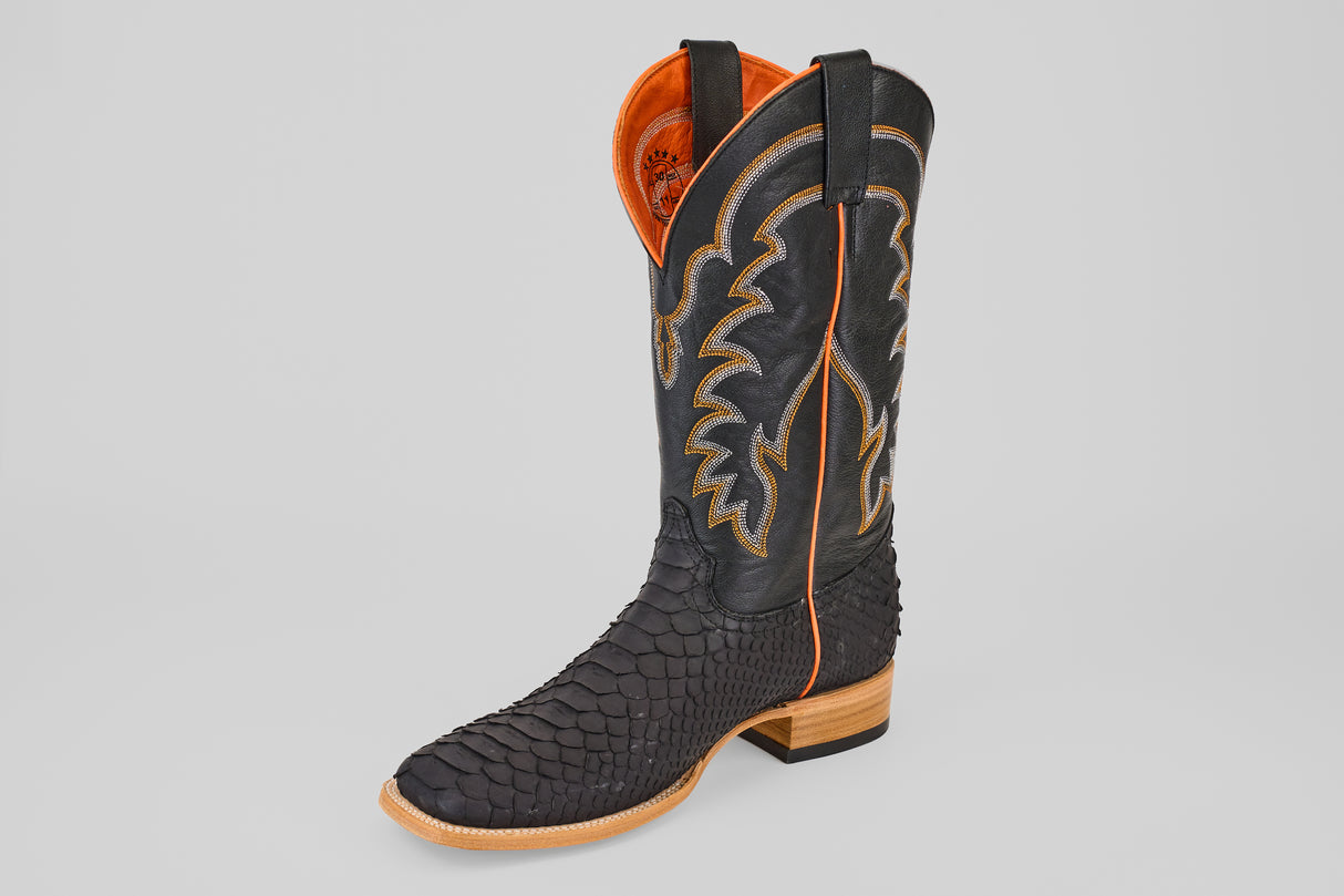 The Wayne - Matte Black - Square Toe boot features a scale-like textured foot, tan stitching and trim, intricate stitching on the shaft, orange lining, wooden sole, and low heel. Part of the Wayne Diamond Collection.