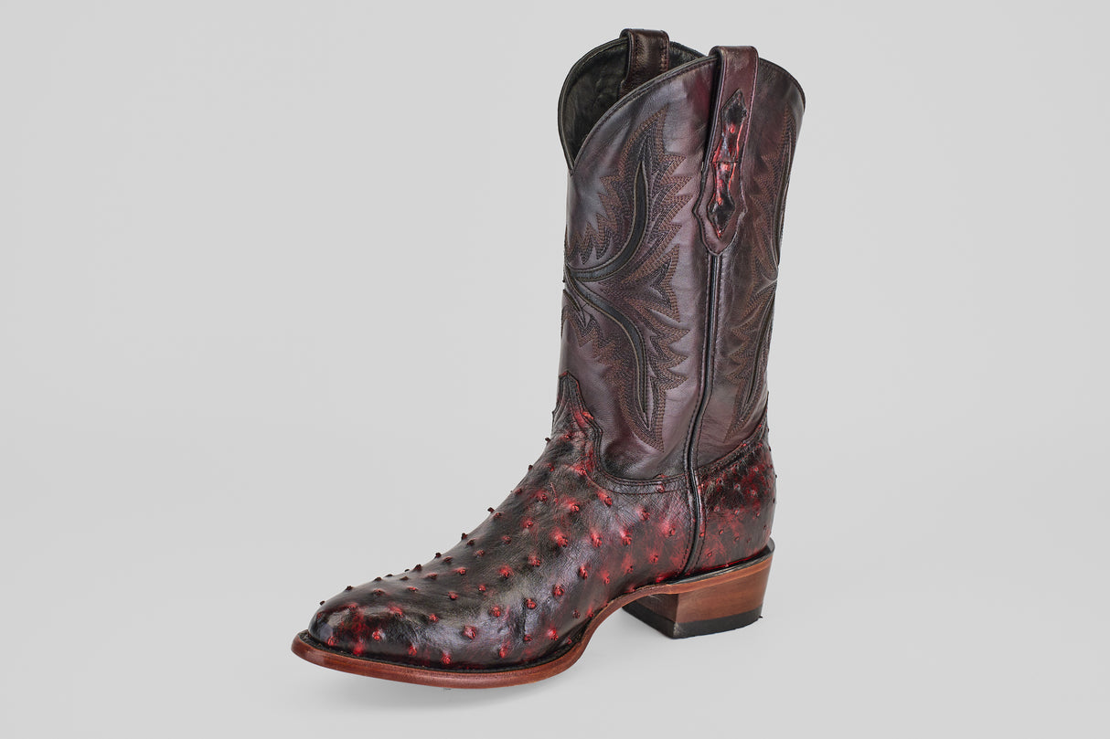 A single Exotic Full Quilt Ostrich - Black Cherry - Round Toe boot, handcrafted in dark brown exotic textured leather with red-toned bumps and decorative upper shaft stitching, displayed against a plain light background.