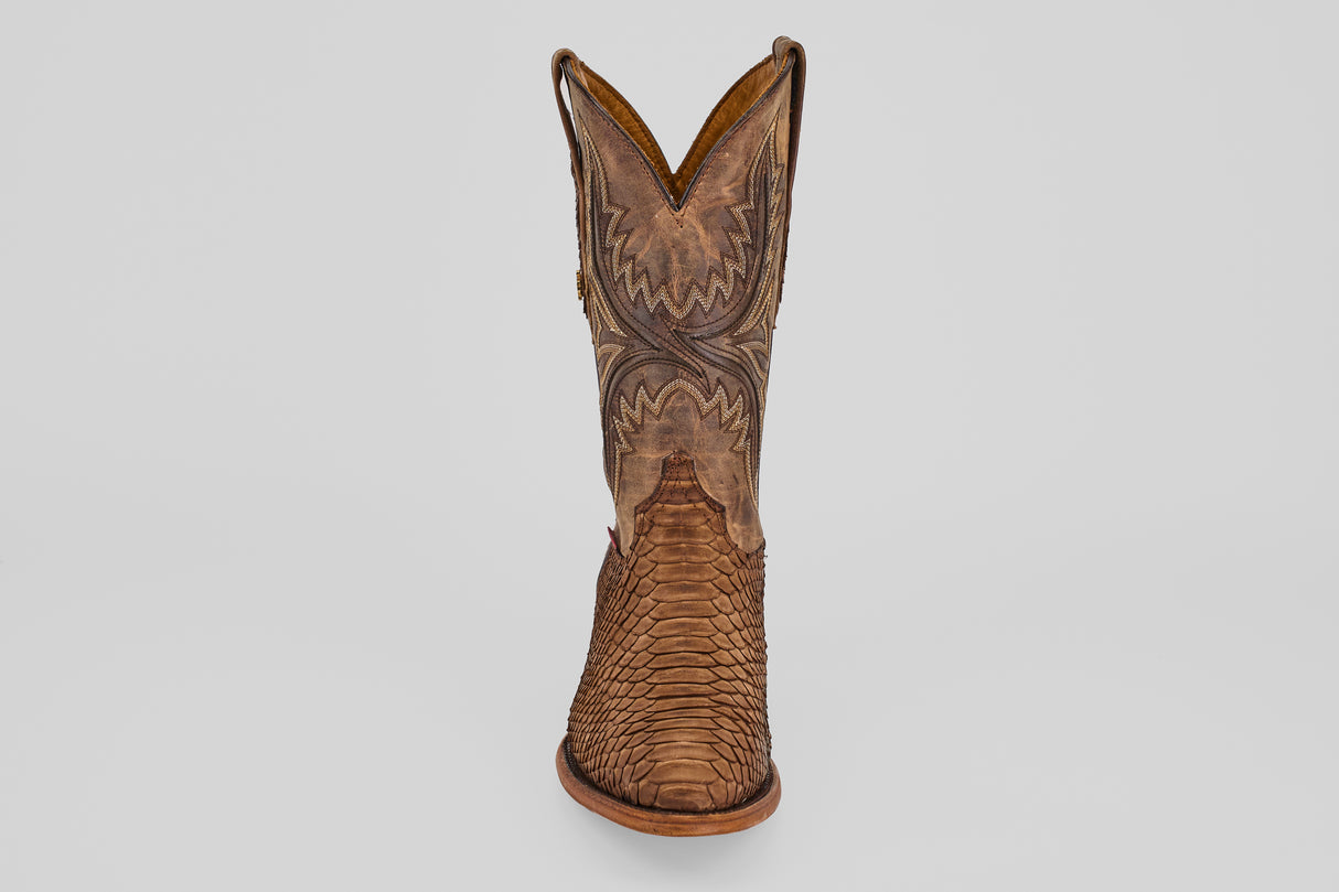 The Tanner - Tamarindo - Round Toe is a single brown cowboy boot featuring intricate stitching and a textured, scaly Python Tamarindo pattern on the foot, displayed front-facing on a plain light background.