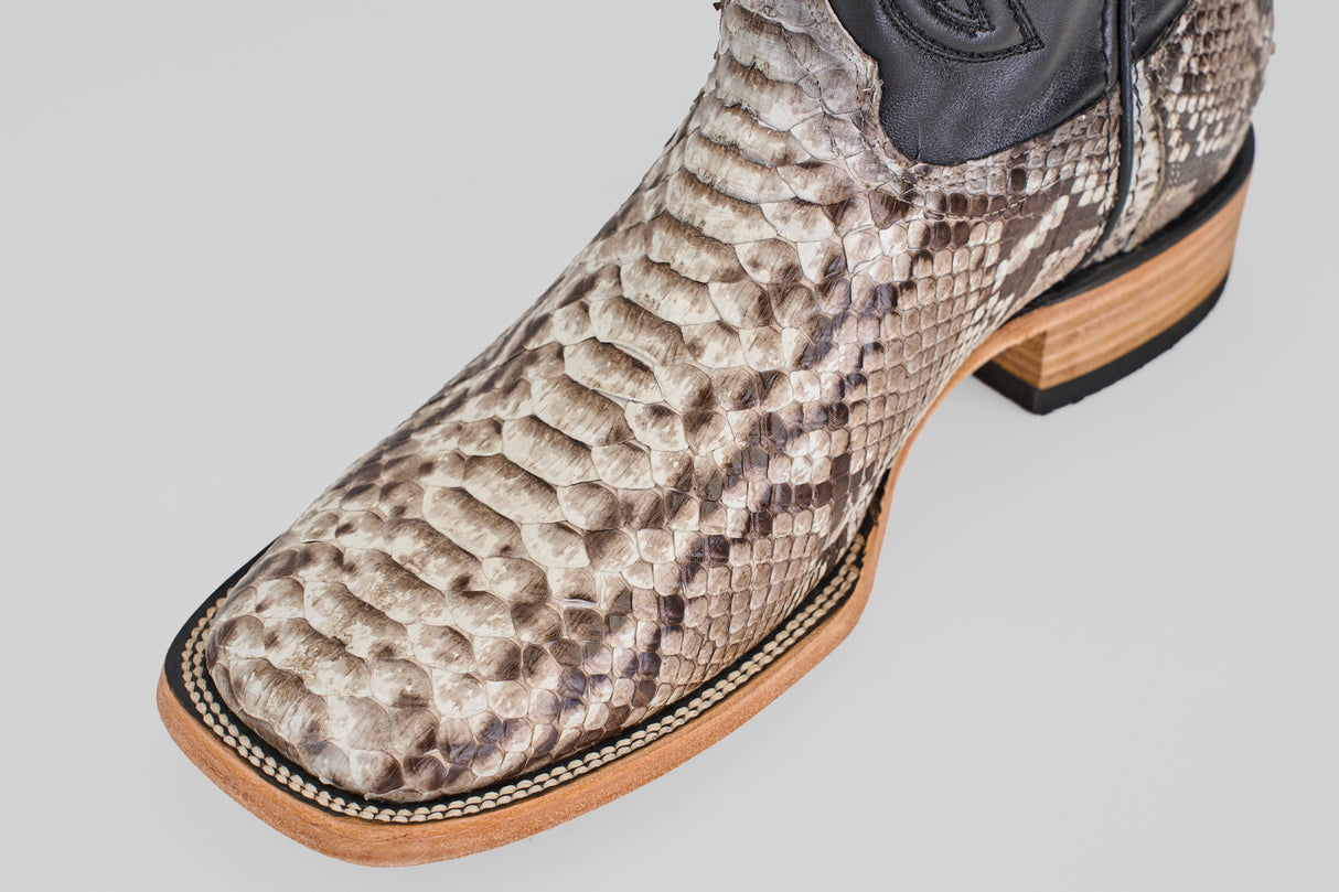 A close-up of the Tanner - Natural - Square Toe boot, showcasing a textured Python Natural snakeskin foot and a light-colored wood sole.
