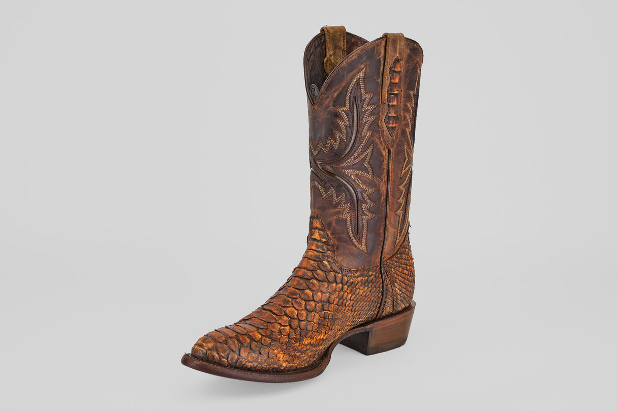 The Tanner – Chestnut – Round Toe boot features a rich brown color, classic western stitching, and a low heel, all set against a plain light gray background for a timeless look.