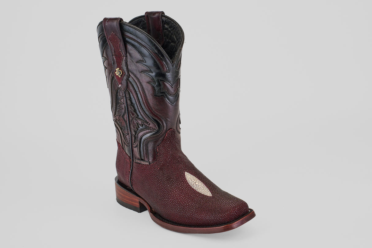 The Ranger – Wine – Rodeo Toe is a single cowboy boot in deep wine color with intricate black stitching and a decorative shaft pattern, finished with a distinct textured stingray leather on the foot, shown on a plain gray background.