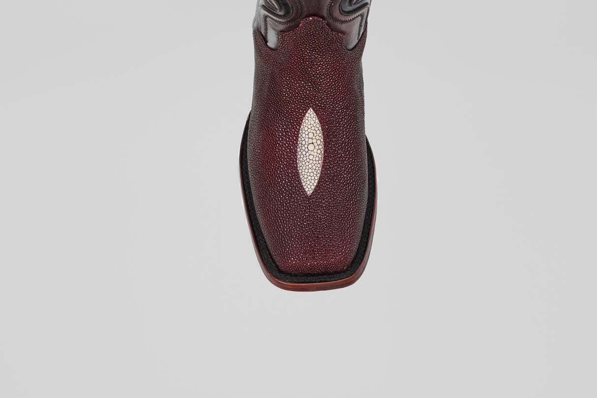 A close-up, top-down view of the Ranger – Wine – Rodeo Toe cowboy boot, showcasing its maroon stingray leather with a white diamond accent and classic rodeo toe, set against a plain light gray background.