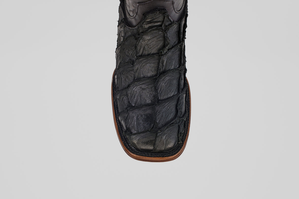 A close-up of the toe of the Conor Platinum - Matte Black - Square Toe (Diamond) boot, featuring black textured material with brown edge stitching—rugged and patterned for a distinctive western style.