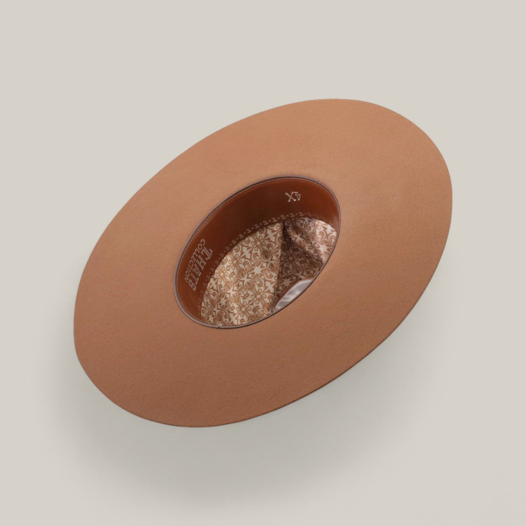 The 4X - Fawn - TC Hats Western hat, shown from above, displays its wide brown brim, inner band, and floral-patterned fabric lining against a plain light beige background.