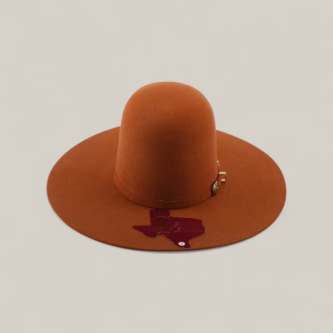 The 4x - Brick - TC Hats is a wide-brimmed, rust-colored Western hat featuring a decorative band and a dark red Texas-shaped patch on the brim, showcased against a plain, light beige background.
