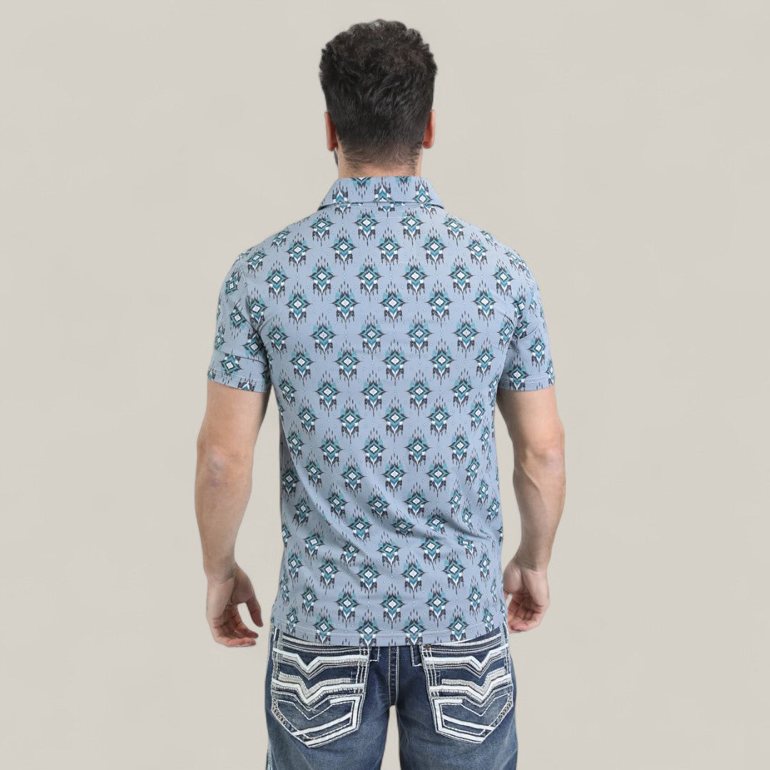 A man is seen from behind, wearing the Mens Performance Fabric Modern Fit Stretch Aztec Print Blue Polo (PGP10871) and blue jeans with white decorative pocket stitching, against a plain light background.