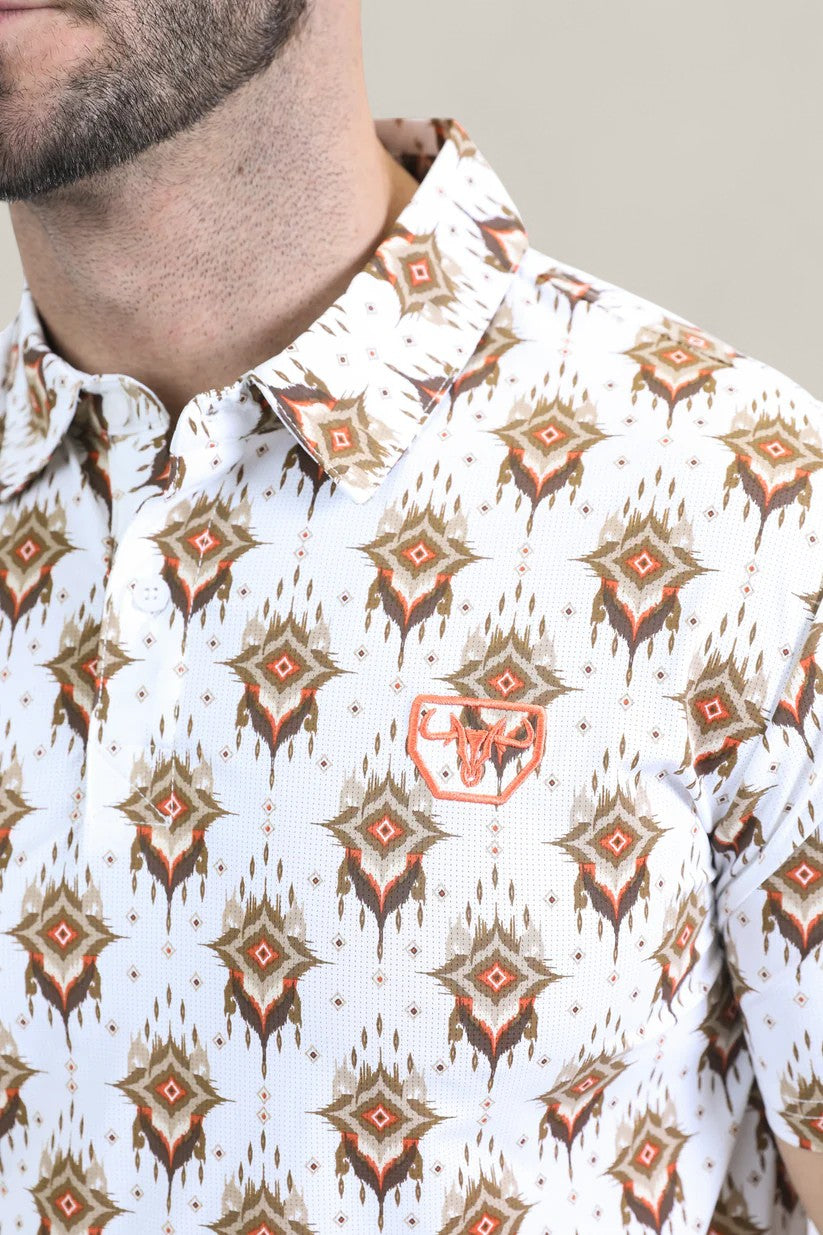 A close-up of a man in the Mens Performance Fabric Modern Fit Stretch Aztec Print White Polo (PGP10870), featuring a brown and orange geometric pattern and an embroidered bull head emblem. Only his lower face and upper torso are visible.