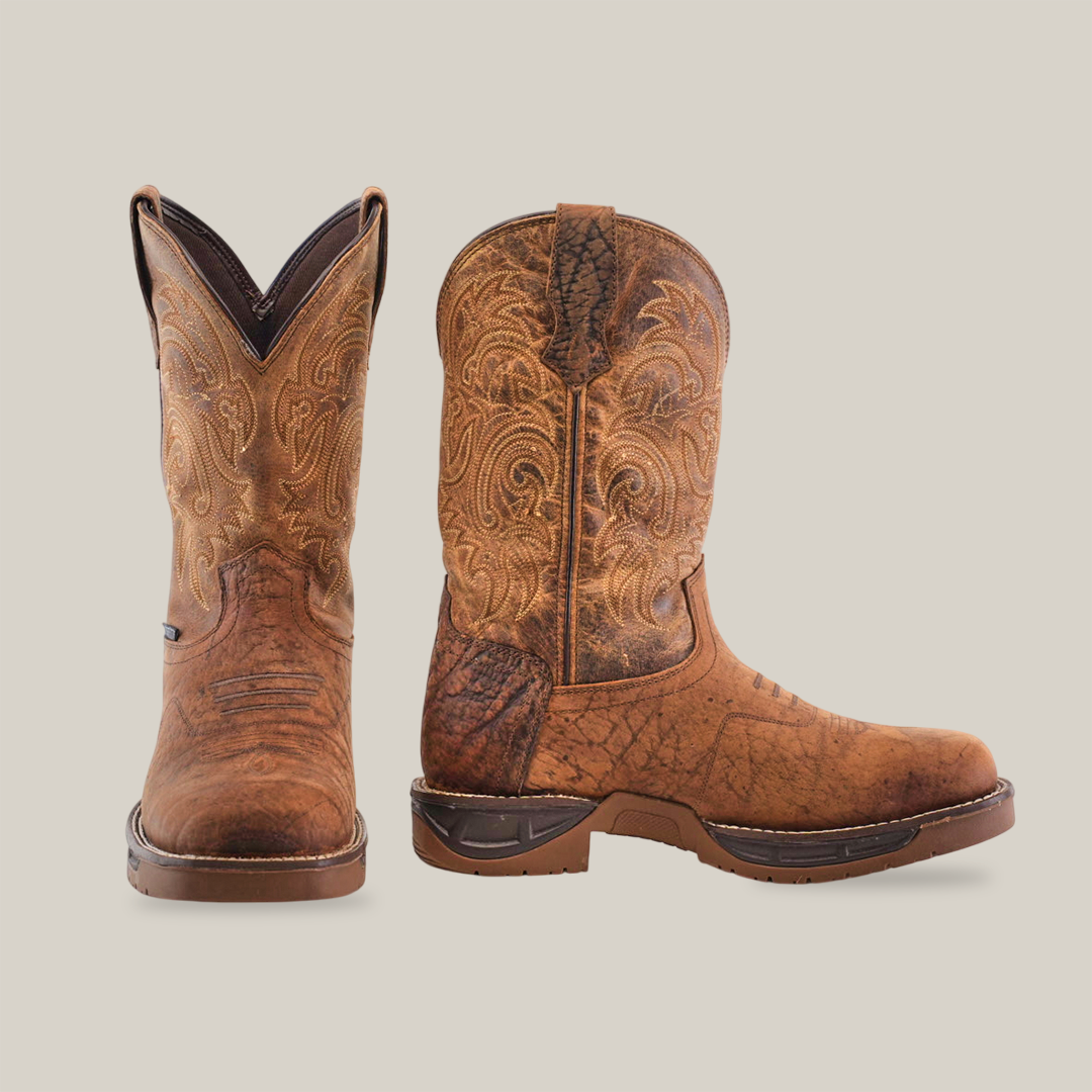 A pair of tan brown waterproof cowboy boots made from premium rough out leather, featuring intricate stitching and a soft square toe design. One boot is shown in side view, the other from the front, highlighting handcrafted excellence against a white background.