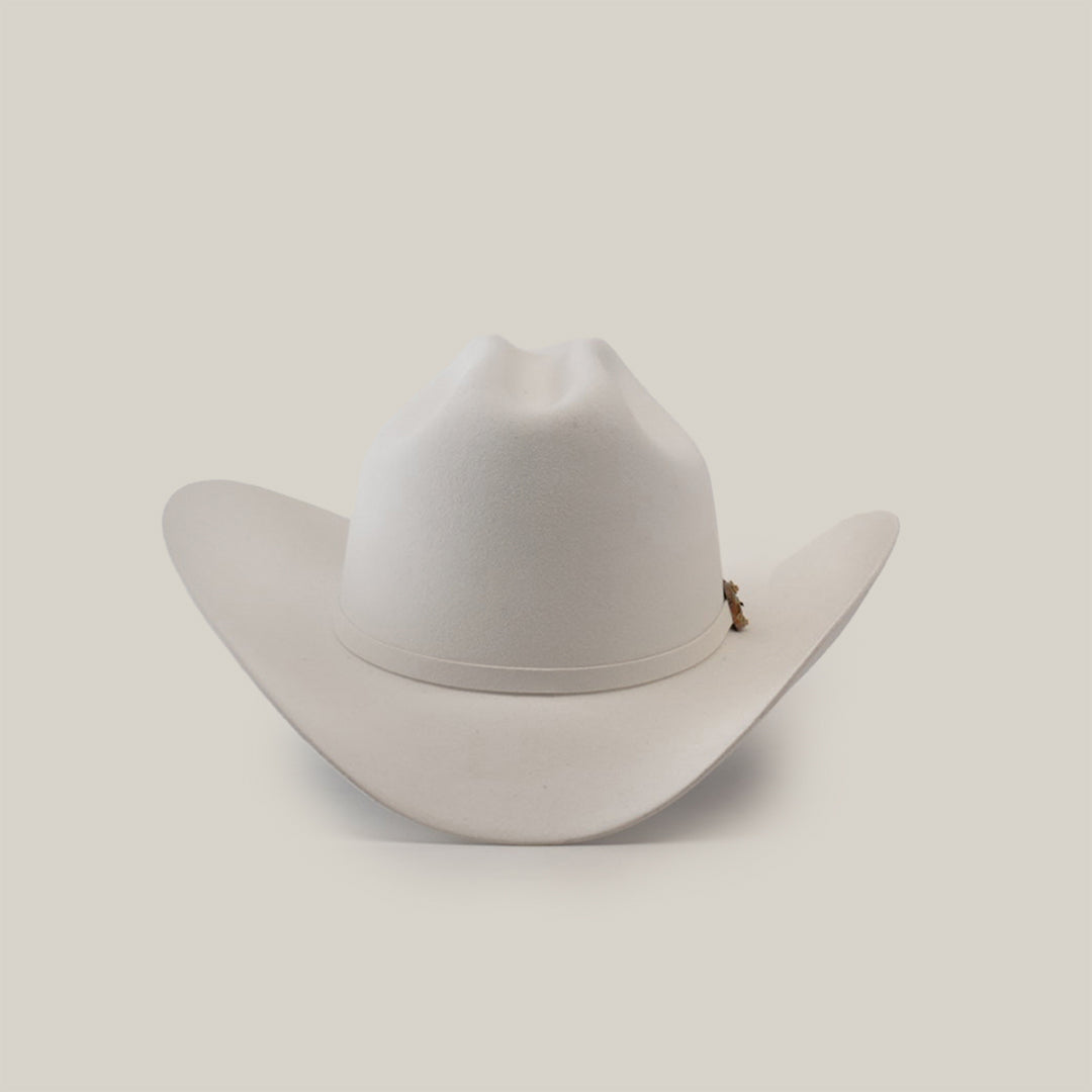 The 1000X Imperial White hat features a wide brim and slightly curved crown against a plain white background. Adorned with a small decorative emblem, this 100% genuine mink accessory exudes charm, sophistication, and style.