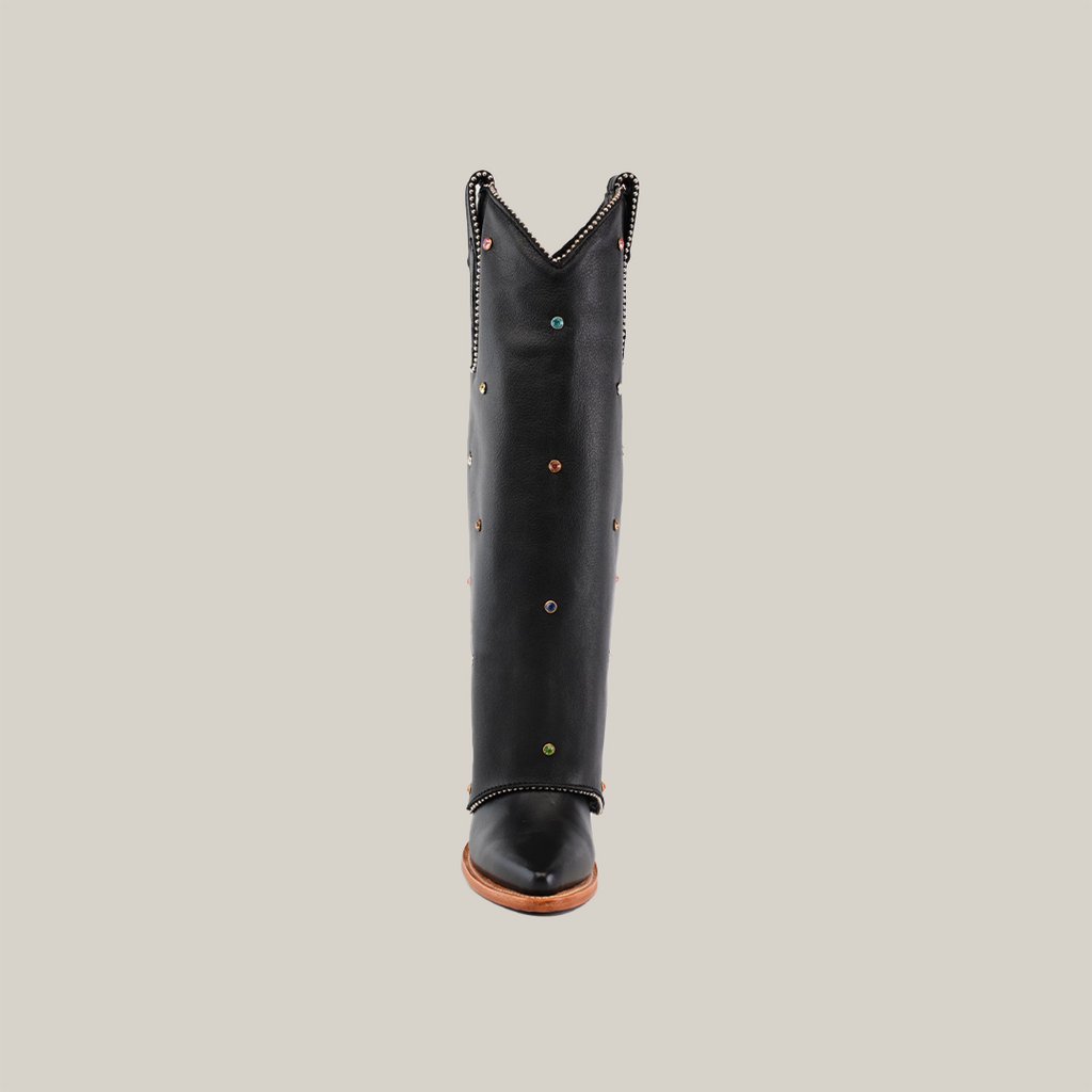 The Roma Rainbow Crystals Tall Shaft Black - J Toe, a knee-high black boot from the Platinum Collection, is adorned with colorful circular studs and decorative trim around the top edge, standing upright against a plain white background for a stylish and eye-catching appearance.