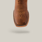 Close-up of a Siberia Honey - Square Toe boot showcasing premium leather, intricate stitching, and a square shape on a light gray background.