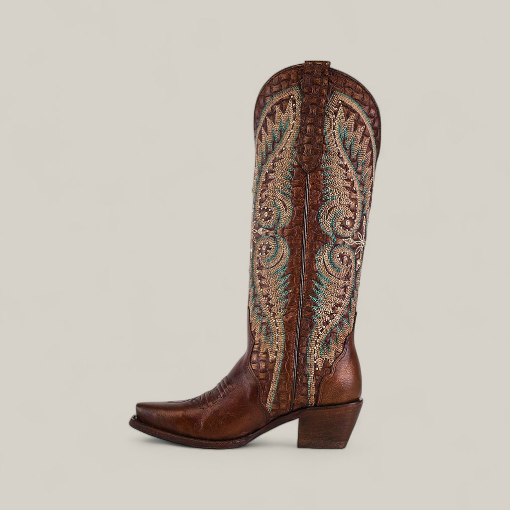 A single Rachael Copper - Tall Shaft - Snip Toe boot in brown leather with multicolored embroidery and stitching on the shaft, a pointed snip toe, and medium stacked heel, shown on a plain light background.