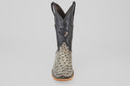 A single mens Exotic Full Quilt Ostrich - Nicotine - Square Toe boot with a textured light gray and black leather foot, black leather upper, decorative stitching, and Texas emblem, shown on a plain white background.