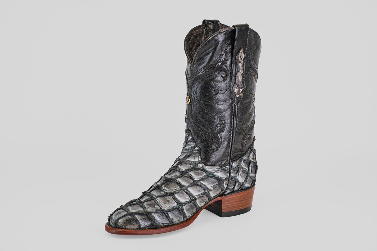 The Conor - Newspaper - Roper Toe is a single black exotic leather boot with a textured reptile-like pattern, wooden heel, and white stitching, shown against a plain light background.