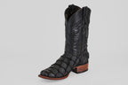 The Conor - Matte Black - Narrow Square Toe boot features a textured, scale-like pattern, decorative stitching on the shaft, and a brown wooden heel and sole. Photographed against a plain light gray background.