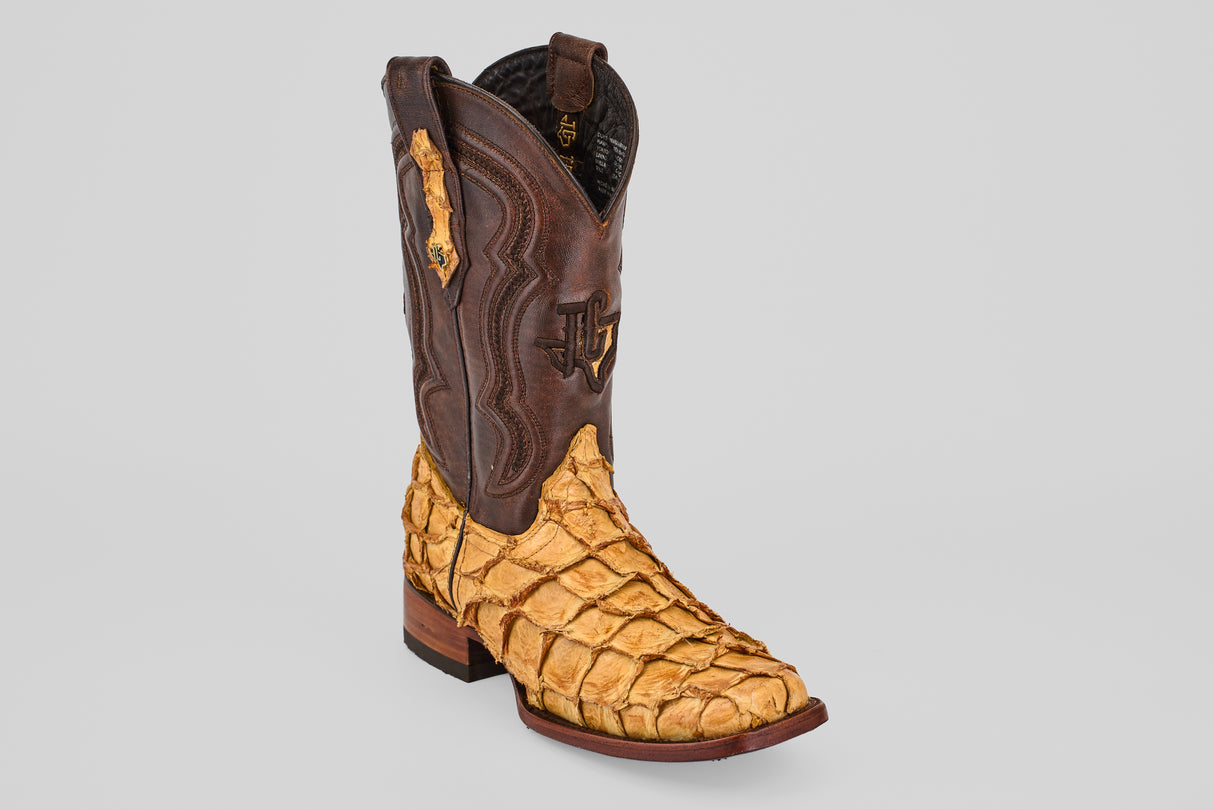 The Conor - Buttercup - Rodeo Toe cowboy boots feature a dark brown leather upper and a light tan, scale-textured lower section made from fish leather, showcased against a plain gray background.