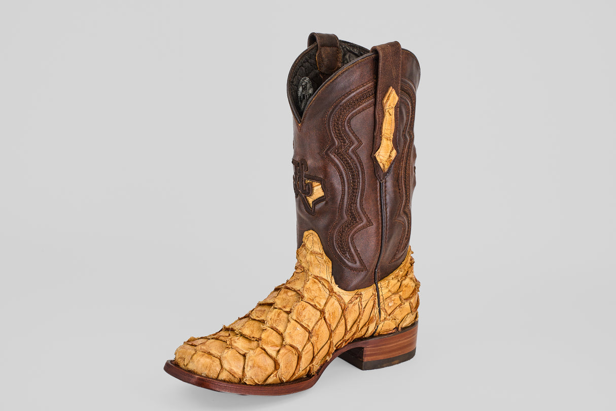 The Conor - Buttercup - Rodeo Toe cowboy boots feature a brown leather upper and textured, tan fish leather lower for standout western style, showcased against a plain light gray background.