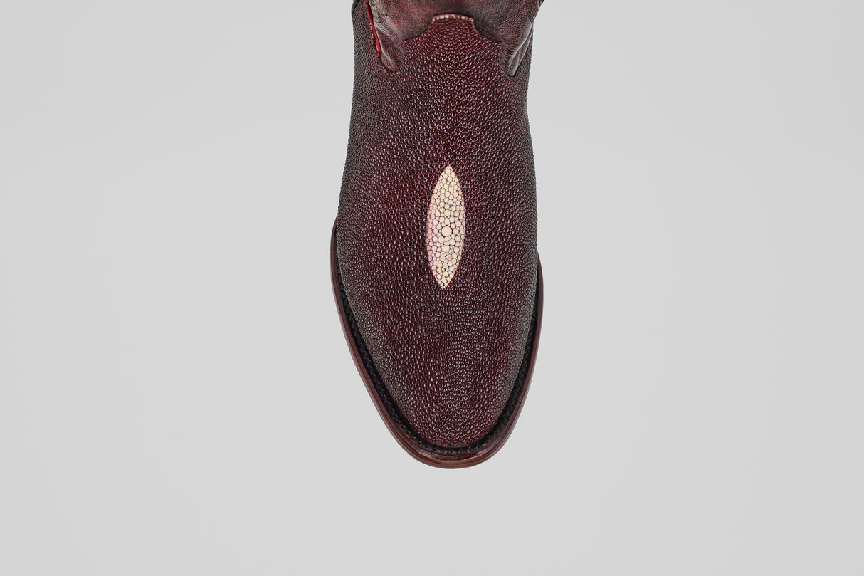 The Ranger – Wine – Round Toe, a single burgundy leather shoe featuring a unique oval light patch on the upper, reminiscent of stingray leather boots, is shown from above against a plain light gray background.