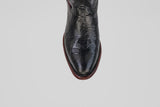 Top view of the Blaze – Black – Round Toe boot featuring black lizard-skin texture and a brown sole, displayed on a plain light gray background.