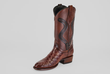 A single James Platimun - Dark Cogñac boot with a roper toe (diamond), featuring textured, crocodile-patterned leather and detailed stitching on the shaft, is shown against a plain light gray background.