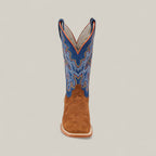 The Buck - Camel - Square Toe boot features a brown suede foot, a tall blue shaft with colorful embroidery, and is shown from the front against a plain light background.